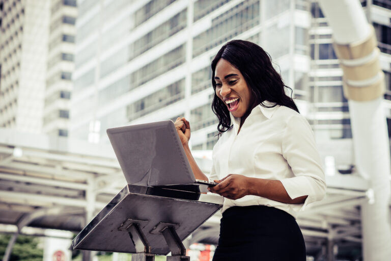 Young woman sitting on staircase using laptop computer